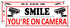 Smile You're on Camera Sign - 2 Pack Video Surveillance Signs, 10" x 3.5" Metal Camera Warning Sign